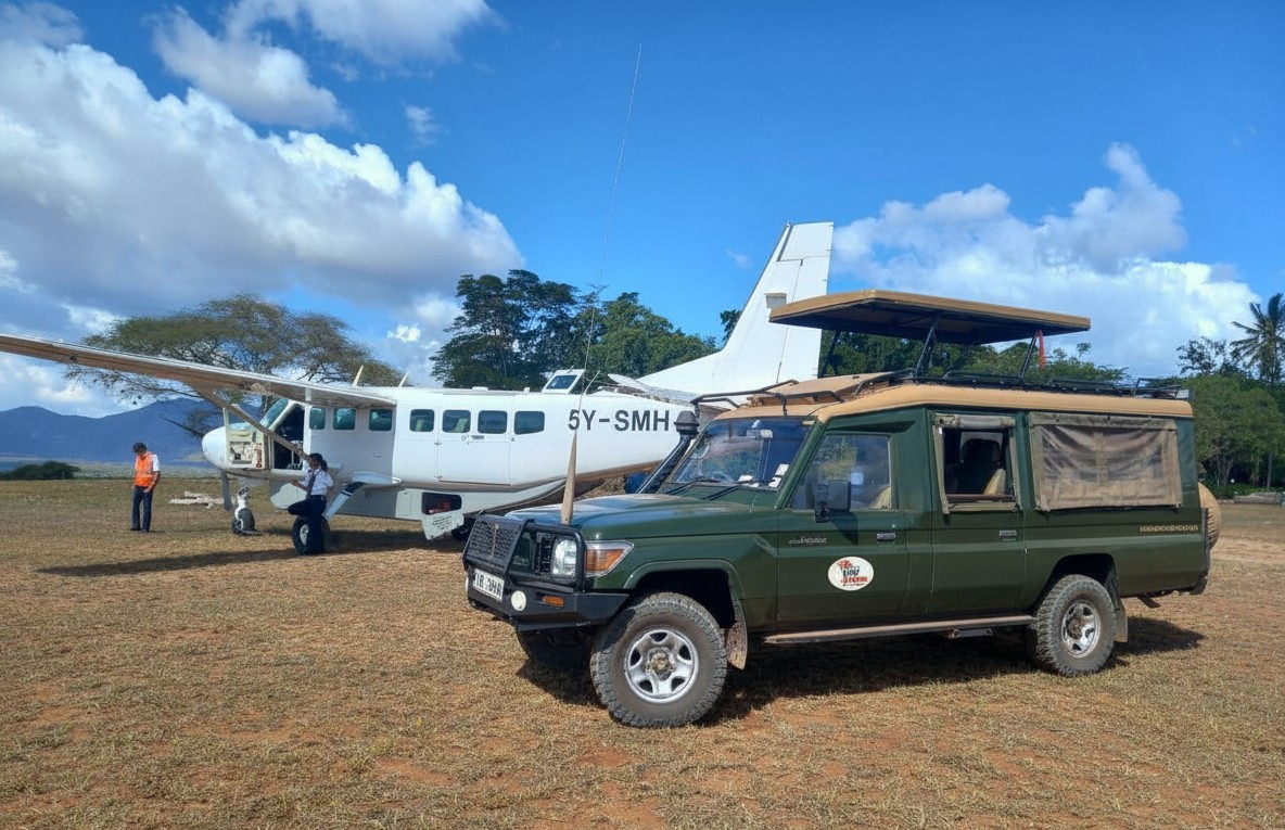 Private aircraft landing at a Masai Mara bush airstrip at golden hour — Wild Race Africa fly-in safari